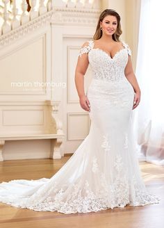 a woman in a white wedding dress posing for the camera