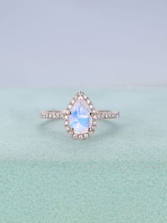 a pear shaped blue topazte and diamond ring