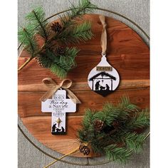 two christmas ornament hanging on a wooden board