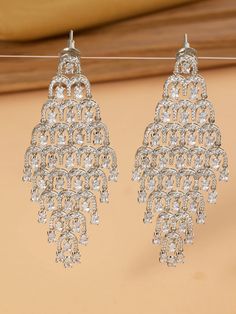 These diamond danglers with CZs offer a stunning blend of classic elegance and modern sparkle. The intricate design features dazzling diamonds complemented by radiant CZs, creating a harmonious play of light and brilliance. Diamond Danglers, Intricate Design, Classic Elegance, Design Features, Diamonds, Sparkle, Design