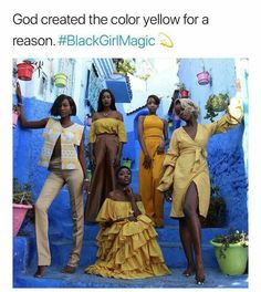 four women in yellow dresses standing on steps with one woman pointing at the camera and another woman holding her hand out