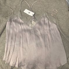 Super Cute Silver Tone Tank Top With A Lace Trim On Top. Has A Silky Feel To It But Is Thick Enough To Not Be See Through At All. The Brand It Socialite. It Is A Size M Brand New From Nordstrom. Tags Still Attached. Party Tank Top With Lace Trim, Party Tops With Lace Trim And Tank Shape, Spring Date Night Camisole With Lace Trim, Spring Camisole Blouse For Night Out, Spring Sleeveless Blouse For Date Night, Sleeveless Blouse For Date Night In Spring, Feminine Lace Top For Summer Night Out, Feminine Lace Top For Night Out In Summer, Feminine Cami Top For Night Out