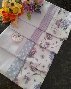 a table topped with lots of different types of flowers on top of napkins next to each other