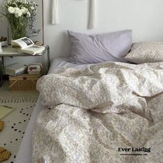 a bedroom with white walls and floral bedding