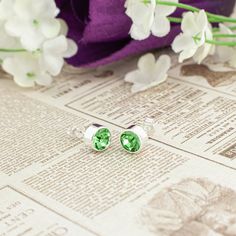 Give the ultimate gift of style with this exquisite pair of 14K gold plated or silver plated crystal earrings. Both earrings are adorned with a 6mm radiant Bohemian crystal in a lustrous light green, like the stone Peridot, the August birthstone. The perfect embodiment of elegance and sophistication. The easy butterfly push on backings make it ideal for everyone, from little girls and teens to adults.  Here are some details you might appreciate: MATERIAL & COLOR: The stud earrings are crafted from high quality 14k gold or silver plated metal, giving it a rich, glossy and lustrous appearance.   EARRING DESIGN: The Bohemian crystal is housed in solid bezel setting with an enclosed back to enhance the crystal's high reflection and shield it from dirt. These earrings have standard 10mm length Round Cubic Zirconia Earrings For Birthday, Green Crystal Earrings For Anniversary, Cubic Zirconia Crystal Earrings For Gift, Gift Crystal Earrings With Cubic Zirconia, Gift Cubic Zirconia Crystal Earrings, Hypoallergenic Green Jewelry For Weddings, Green Crystal Earrings For May Birthstone Gift, Green Earrings For Anniversary, May Birthstone, Green Crystal May Birthstone Earrings For Gift