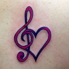 a heart with a treble tattoo on it