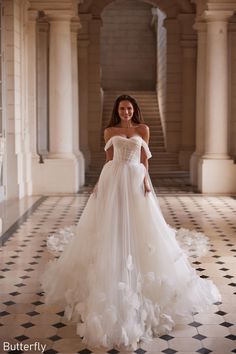 a woman in a white wedding dress standing on a checkered floor with her arms behind her back