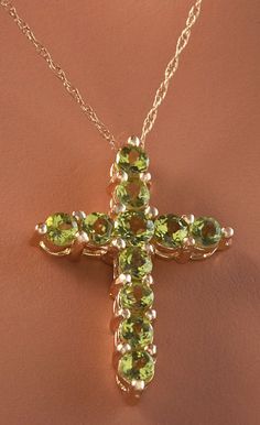 1.20 Carat Natural Green Peridot 14K Solid Yellow Gold Cross Pendant with Chain Amazing looking piece! Suggested Replacement Value: Approx. $1600.00 Total Natural Round Cut Green Peridots Weight: 1.20 Carat Chain Length is: 16 inches Pendant measures: Approx. 25 x 18.4mm Total item weight is: Approx. 2.1g Disclaimer: all weights, measurements and colors are approximate and may vary slightly from the listed dimensions or as seen in the image. All pictures are magnified to show the smallest of det Luxury Peridot Jewelry For Formal Occasions, Luxury Yellow Gold Peridot Jewelry, Luxury Gold Jewelry With Peridot, Luxury Gold Peridot Jewelry, Peridot Jewelry With Gemstone Accents, Luxury Peridot Jewelry For Gifts, Formal Peridot Jewelry For May Birthstone, Luxury Peridot Multi-stone Jewelry, Luxury Multi-stone Peridot Jewelry