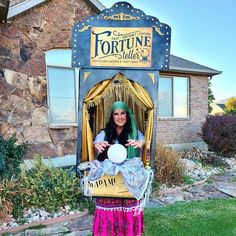 a woman dressed as a princess in front of a tortue shell store display