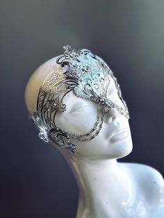 Step into the realm of goddesses with our women's masquerade mask in silver. Rhinestones delicately embellish the mask, adding a touch of sparkle. Silver chains gracefully adorn the mask, creating an enchanting movement. Capture attention at any masquerade party, ball, or themed event!


Age Group/Gender - Adult/Women

Size/Type - One size fits all adults

Mask Color - Silver

Mask Material - Laser Cut Metal

Special Features - Chains and rhinestones Silver Rhinestone Body Jewelry For Festivals, Festival Silver Body Jewelry With Rhinestones, Silver Adjustable Headpieces For Carnival, Adjustable Silver Headpiece For Carnival, Adjustable Full Face Mask For Masquerade, Glamorous Silver Headpieces For Party, Silver Metal Body Jewelry For Evening, Elegant Adjustable Silver Headpieces, Adjustable Eye Mask For Festival