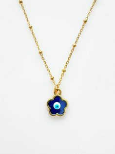 How adorable is this charm? Handpainted and one of a kind with a shimmery blue touch. So dainty and feminine while keeping you fashionably protected from the evil eye. The evil eye design is handpainted adorned on a tarnish resistant 18inch satellite style stainless steel chain.  Comes with my custom storage jewelry pouch to store.  Each design is one of a kind. custom painted in Istanbul. Adjustable Blue Necklaces With Charms, Blue Bohemian Necklace With Flower Charm, Blue Dainty Charm Necklaces, Blue Flower Pendant Necklace Nickel Free, Dainty Blue Necklaces With Charms, Blue Nickel-free Flower Pendant Necklace, Blue Amulet Necklace For Good Luck, Spiritual Blue Charm Necklace, Blue Pendant Necklaces With Flower Charm