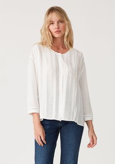 A pretty bohemian button-front blouse with delicate pleated details throughout. Linen blend Relaxed fit 3/4 length sleeve Single-button wrist closure Side vents Round neckline Button-front Lattice trim Pleated details throughout Slightly sheer Bohemian blouse Delicate pintuck details elevate this simple yet sophisticated bohemian blouse. With flattering 3/4 length sleeves, a round neckline, and a button front. Perfect for spring into summer, we love to pair it with a flat sandal and denim. Model Spring Relaxed Fit Blouse With Placket, Relaxed Fit Blouse With Placket For Spring, Casual Long Sleeve Top With Pintucks, Spring Feminine Blouse With Pintucks, Feminine Spring Blouse With Pintucks, Feminine Pintuck Top For Summer, Feminine Summer Top With Pintucks, Feminine Pintucks Top For Summer, Casual Pintuck Blouse For Summer