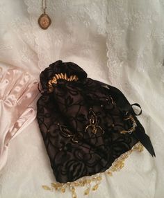 Handmade Regency/Edwardian purse. Made of cappuccino satin, black velvet lace and ribbon and lots of beads. Can be made in almost any colour. Victorian Style Black Bag For Vintage Events, Black Victorian Bag For Vintage Events, Handmade Black Bag For Wedding, Victorian Pouch Bags As Gifts, Victorian Style Pouch Bag As Gift, Victorian Style Pouch Bag For Gift, Victorian Pouch Bag For Gift, Victorian Gold Bag As Gift, Handmade Victorian Bags