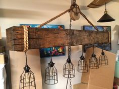 several hanging lights made out of wood and wire