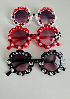 The cutest sunglasses to showcase your school spirit! Perfect for sporting events, high school games, and spirit days.  Personalization: These are available on white, black, red, orange, or blue frames. All of them will have either the large pearls or rhinestones as shown, but the main rhinestone color will change based on requested team colors. Please be specific about colors (ex: navy blue, bright orange) For multiple words, they'll be split between the two lenses unless otherwise requested. High School Games, Girls Sunglasses, Spirit Days, Girls Sports, Cute Sunglasses, School Games, Girl With Sunglasses, Blue Frames, Sports Sunglasses