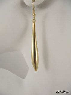 Long, simple and elegant.  What a perfect accent to any outfit.These gold plated earrings are so sophisticated and sleek - and so much fun to wear!  They are finished off with gold plated ear wires.  The ear wires can be switched out to stainless steel, for those with sensitive ears, or gold plated clip-ons at no additional charge. Simply select your option before adding to your cart.Total height from top of ear wire to bottom of the drop is approximately 2.75 inches.Width at the widest point of Elegant Matte Gold Earrings For Party, Elegant Matte Gold Party Earrings, Gold Minimalist Earrings For Evening, Classic Gold Earrings For Party, Gold Teardrop Linear Earrings In Minimalist Style, Gold Long Drop Teardrop Earrings For Party, Modern Gold Teardrop Earrings For Formal Events, Modern Gold Teardrop Earrings For Formal Occasions, Gold Minimalist Drop Earrings