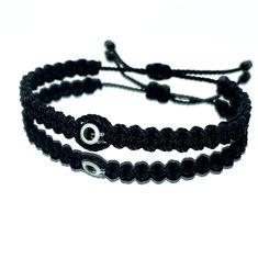 Hand-Made Black String Bracelet With An Evil Eye For Wrist Sizes 6 To 9 Inches, With An Easy To Use Zip Like Function To Fit Your Wrist. Made From High Quality Black String, It Will Be Sure To Last. Wearing An Evil Eye As An Amulet Is Believed To Provide Protection Against Evil Forces. The Evil Eye Meaning Has Symbolism In Almost Every Country In The World And In Every Religion. Each Bracelet Is Carefully Handcrafted And Give Proper Time To Ensure Quality. Handmade Black Braided Casual Bracelet, Handmade Black Casual Braided Bracelet, Casual Black Handmade Braided Bracelets, Casual Black Handmade Braided Bracelet, Black Adjustable Friendship Bracelets, Handmade Black Wristband For Friendship, Casual Black Beaded Bracelets For Friendship, Trendy Black Friendship Jewelry, Elegant Black Braided Bracelets For Friendship