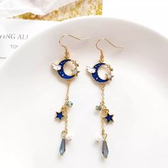 Boho Blue And Gold Crystal Star And Moon Dangle Earrings These Beautiful Earrings Have A Blue Half Moon At The Top With A Little Cloud, Tiny Gold Stars With Crystals, And Dangling Down Are Blue Beads, Faux Pearls, And Blue Stars. A Great Gift For A Friend Who Loves To Star Gaze! Measurements In The Last Picture Zinc Alloy, Crystals, Enamel, Beads Comes With A Sheer Organza Gift Bag Bohemian, Fairy, Whimsical, Romantic, Hippie, Gypsy, Celestial, Bff Gift, Celebration, Birthday, Anniversary, Stock Fairy Whimsical, Bohemian Fairy, Star And Moon Earrings, Star Gaze, Purple Heart Earrings, Whimsical Romantic, Moon Drop, Flower Resin Jewelry, Bff Gift