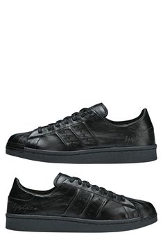 A monochromatic upper with decorative stitching adds a clean, sporty vibe to a low-profile leather sneaker set on a rubber cupsole. Lace-up style Removable insole Leather upper/textile lining/rubber sole Imported Black Leather Adidas Sneakers, Decorative Stitching, Sneaker Men, Up Styles, Leather Sneakers, Low Profile, Rubber Sole, Leather Upper, Stitching