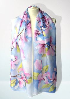 Hand panted silk scarf 'Magnolia Flowers' is a long silk scarves from delicate and light weight, decorated with magnolia flowers on a pastel baby blue skies. Size: about 61 by 17 in (155 by 43 cm) Silk: natural Habotai Light, which is a delicate, semi transparent fabric, with a glossy quality. Silk scarf 'Magnolia Flowers' is made to order! It will take me up to 3 days to paint a similar scarf, please note that I don't use patterns and the scarf for you will be unique and slightly different from Pink Feminine Silk Scarf, Pink Silk Shawl For Spring, Pink Floral Print Feminine Scarves, Pink Feminine Floral Print Scarves, Feminine Pink Floral Print Scarves, Pink Silk Scarf With Floral Print, Pink Floral Print Silk Scarves, Bohemian Pink Floral Print Silk Scarf, Pink Silk Shawl Scarf