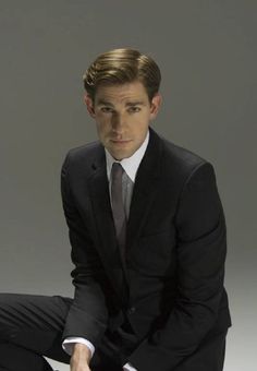 a man in a suit and tie sitting down