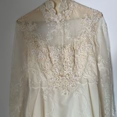 Wedding Dress From 60s Or 70s. Never Worn. Dress Says Size 8. Unknown If It Is True To Size. Non Smoking And Bug Free Home. We Do Have Dogs But They Have Not Been Near The Dress. Beautiful Bead Work And Small Train. 70 Wedding Dress Vintage 70s, Classic A-line Vintage Wedding Dress, 1950s Fitted Wedding Dress, 1970s Fitted Vintage Wedding Dress, 1970s Fitted Wedding Dress, 1970s Style Fitted Wedding Dress, Retro Long Sleeve Dresses For Vintage Events, Long Sleeve Lace Retro Vintage Dress, White Retro Vintage Dress With Fitted Bodice