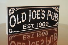 an old joe's pub sign is displayed on a table