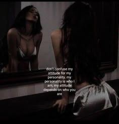 a woman looking at herself in the mirror with her hand on her hip and another person's reflection behind her