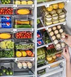 the refrigerator door is open and filled with lots of fresh vegetables, eggs, and fruit