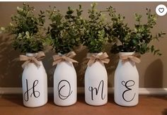 three vases with flowers in them sitting on a table