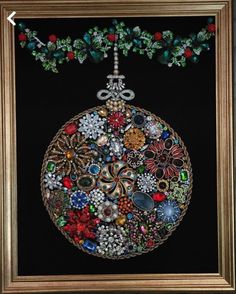 a christmas ornament hanging from a gold frame