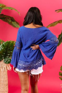 We think you'll agree when we tell you how "haute" this charming royal blue top is featuring lightweight breezy material with intricate semi-sheer crochet detailing, a v-cut neckline with a tie closure, long oversized sleeves with ultra flared forearm cuffs, and a relaxed silhouette that falls into a scalloped tunic length hemline!