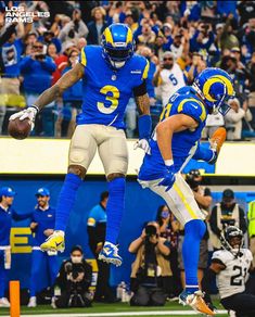 two football players are jumping in the air