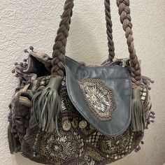 Anthropology Embellished Bag Gray In Color. Condition Good Normal Wear. Size Large. Great Everyday Bag. Look At Pictures For Details Of Bag Condition. Inside Of Bag Good Condition. All Sales Final No Returns Chic Embellished Leather Bag, Embellished Leather Top Handle Shoulder Bag, Embellished Leather Rectangular Shoulder Bag, Bohemian Bag With Detachable Strap, Luxury Embellished Tote Shoulder Bag, Luxury Embellished Tote Bag, Bohemian Embellished Shoulder Bag For Everyday, Elegant Embellished Shoulder Bag For Travel, Embellished Tote Shoulder Bag For Everyday Use