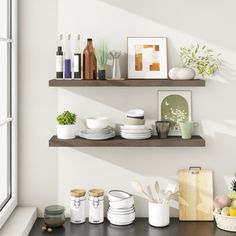 two wooden shelves filled with dishes next to a window