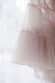 there is a dress hanging in front of a window with snowflakes on it