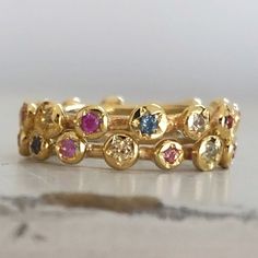 Eternity Gold Ring, Gold Sapphire Ring, Engagement Ring, Eternity Band, Gold Stacking band, Sapphire Engagement Ring, Anniversary Ring. Original and unique gold band with multi color sapphires set all around. Delicate and very classic, fine piece of jewelry. Solid 14 karat Gold, hand crafted. You can wear it as a single band, or stack it up for extra vibrant colors. Details - * 14 karat solid yellow gold. * Multi color Sapphires, set all around (14 stones all together). * Width - 3.5 mm / 0.4 in Yellow Gold Multi-stone Stackable Promise Rings, 14k Gold Multi-stone Eternity Band, Gold Multi-stone Stackable Rings Gift, Multicolor Stackable Sapphire Ring Fine Jewelry, Multicolor Stackable Round Band Rings For Anniversary, Multicolor Stackable Rings For Anniversary, Multi-stone Stackable Promise Rings, Multi-stone Stackable Rings For Promise, Gold Multi-stone Sapphire Promise Ring