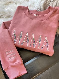 a pink sweatshirt with the word mama written on it and sequins around the letters