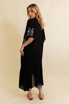 Introducing our Boho Tribal Embroidered Longline Kimono – a statement piece that effortlessly blends style and cultural flair! This longline kimono features intricate tribal embroidery, adding a bohemian touch to your wardrobe. With a relaxed fit and flowing silhouette, it's perfect for layering over any outfit. Whether you're hitting the festival scene or looking for a boho-chic layer for everyday wear, this kimono has you covered. Elevate your style with the Boho Tribal Embroidered Longline Kimono – where fashion meets cultural inspiration in one stunning piece! #lovemyleto 100% Viscose Imported Long Floral Embroidered Kimono For Festival, Long Floral Embroidery Kimono For Festivals, Summer Folk Style Embroidered Kimono, Embroidered Folk Kimono For Summer, Summer Embroidered Folk Kimono, Bohemian Style Unlined Kaftan, Intricately Embroidered Beach Kaftan For Spring, Spring Beach Kaftan With Intricate Embroidery, Bohemian Cotton Kimono With Floral Embroidery