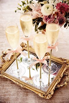 an image of some champagne glasses on a tray with flowers in the background and text that reads diy wedding ideas, decorations & more