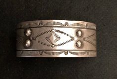 Early stamped silver bracelet. Purchased from Lynn Trusdell's Collection. This bracelet is absolutely beautiful with excellent detailed stamping. It is also in outstanding condition!  This is an exceptional piece and would be a great addition to any collection. This bracelet fits a 7" wrist and has a 1 1/4" opening. Weight: 32.7 grams. I used different backgrounds and lighting for your viewing. Free Insured Shipping between now and Christmas! Vintage Bangle Bracelet With Polished Finish, Vintage Bangle Bracelets With Polished Finish, Vintage Round 925 Stamped Bracelets, Vintage 925 Stamped Bracelet, Vintage Wedding Bangle With Polished Finish, Vintage Sterling Silver Etched Bracelets, Vintage Sterling Silver Bracelets Engraved, Vintage Sterling Silver Bracelet For Anniversary, Classic Etched Sterling Silver Bracelet