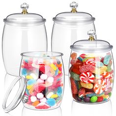 three glass jars filled with candy and candies