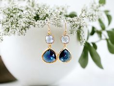 "These stunning Sapphire Earrings are the perfect addition to any jewelry collection. Handmade with care Classy blue color Dangle style with gold accents. Suitable for any occasion, including weddings and bridesmaid gifts. Their classic design is sure to make a statement and elevate any outfit. They are carefully crafted with attention to detail, making them a unique and special addition to your jewelry collection. The beautiful blue color of these earrings is truly captivating. The gold accents add an extra touch of elegance, making these earrings perfect for special occasions or everyday wear. If you're looking for a one-of-a-kind gift, then look no further. Whether you're shopping for yourself or someone special in your life, these Sapphire Earrings are sure to impress! Color = Light Sa Elegant Blue Crystal Earrings For Gift, Blue Birthstone Earrings For Wedding, Blue Dangle Earrings For Bridesmaids, Blue Dangle Bridal Earrings Gift, Blue Teardrop Earrings For Anniversary, Blue Dangle Teardrop Earrings For Anniversary, Blue Teardrop Bridal Earrings For Anniversary, Blue Jewelry With Matching Earrings For Bridesmaid Gift, Blue Drop Earrings For Bridal Gift