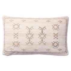 a white pillow with an embroidered design on the front and back, sitting on a white surface