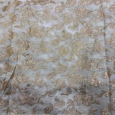 the fabric has gold flowers on it and is light blue with brown trimmings