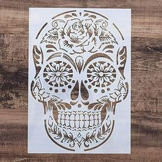 a sticker that is on top of a wooden surface with a skull and roses