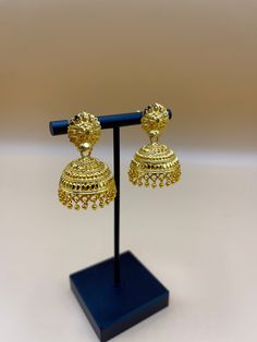 Indulge in the timeless allure of our 24k Polished Earrings, a true embodiment of elegance and luxury. Meticulously handcrafted by skilled artisans from Nepal, these exquisite earrings are crafted from pure 24k gold, radiating a lustrous and polished finish. The intricate detailing and traditional designs pay homage to  rich cultural heritage, making each piece a work of art. Elevate your style and make a statement with these opulent earrings, a perfect accessory for special occasions or adding Traditional 22k Gold Bridal Earrings For Festive Occasions, Bollywood Bridal Earrings With Intricate Design For Ceremonial, 22k Gold Jhumkas For Ceremonial Navratri, Traditional Yellow Gold Jhumkas For Wedding, Yellow Gold Jhumkas With Latkans For Wedding, Festive 22k Gold Jhumkas For Ceremonial Occasions, Ceremonial 22k Gold Jhumkas For Festive Occasions, Festive Yellow Gold Jhumkas For Diwali, Festive Ceremonial 22k Gold Jhumkas