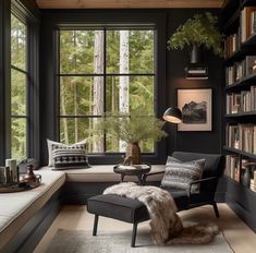 a living room filled with lots of furniture and bookshelves next to a window