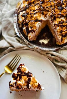 a piece of cake sitting on top of a white plate next to a knife and fork