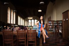 a woman sitting at a table in a library